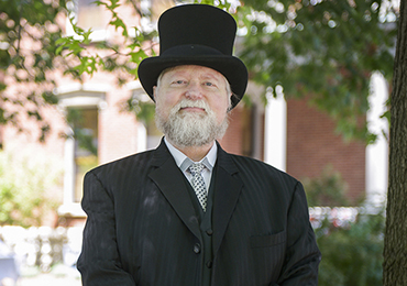 Photograph of Harrison reenactor, posing in front of the mansion.