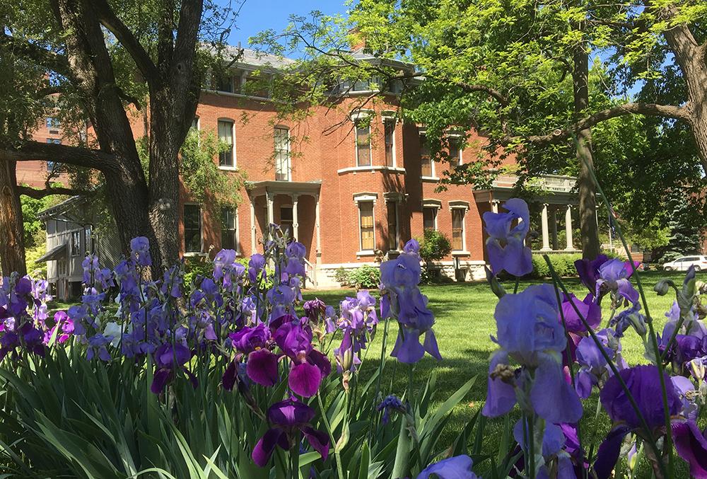 Photographic image of the Harrison mansion and irises.