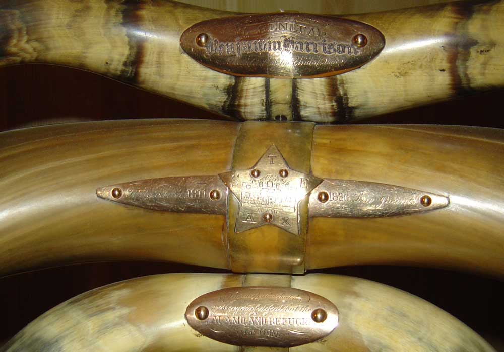 Micro photograph of a chair gifted to benjamin harrison crafted from bull's horns. There photo shows three horns that can be found on the back of the chair, held together with metal screwed into the horns.