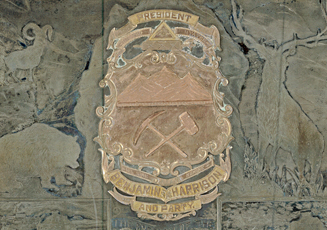 A heavy gray metal (silver or silver plated) and copper plaque from the city of Glenwood Springs, Colorado presented to Benjamin Harrison. The edge of the metal plaque has a fancy boarder and the corners are notched. In the center in copper (on top of base metal); 