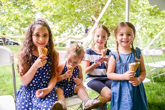 photograph of a group of young girls photographed at a benjamin harrison presidential site event, each eating an ice cream cone on a warm summer's day.
