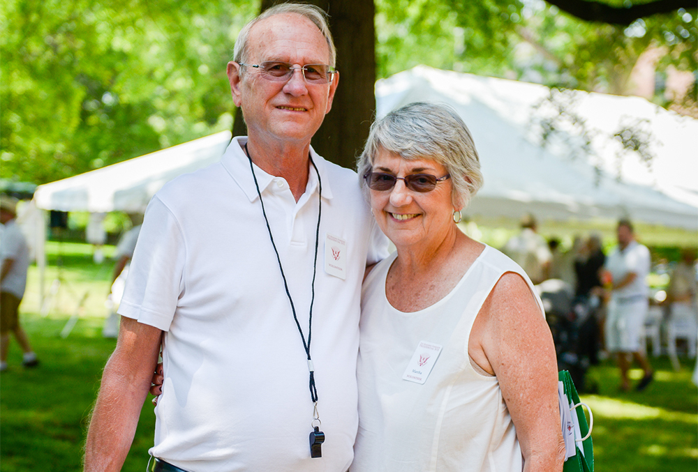 This photograph shows Martha and her husband, Dave, embraced and cheerily grinning at an outdoors event at Benjamin Harrison Presidential Site on a warm day.