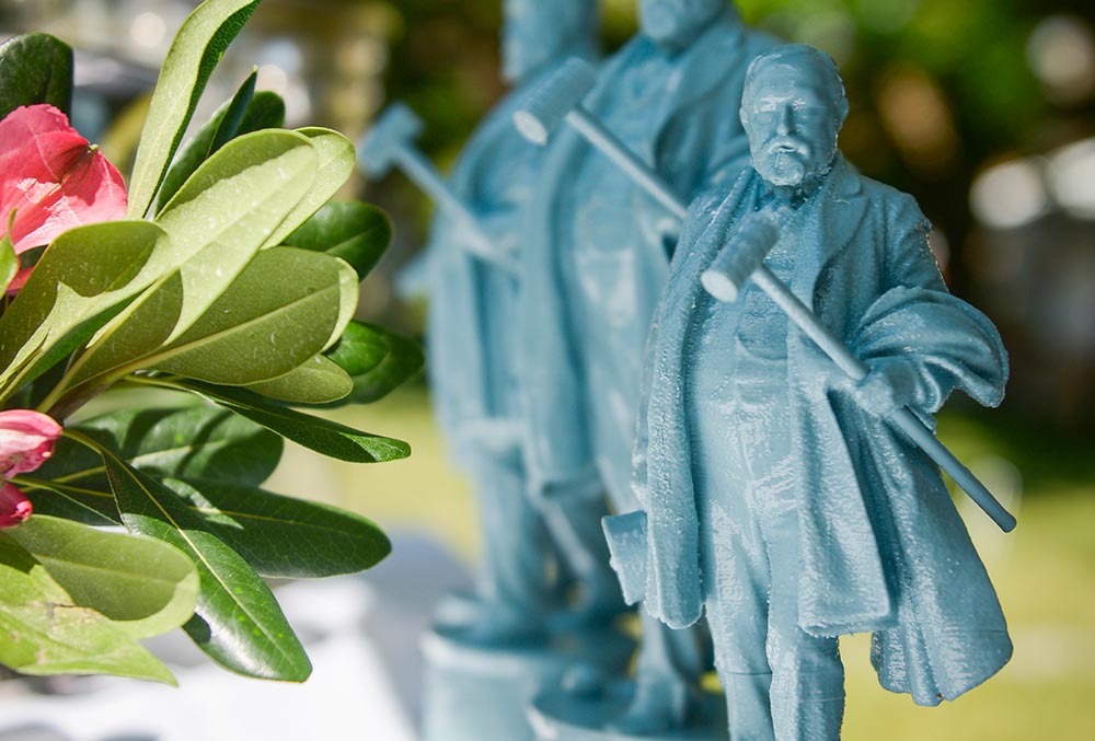 photo of several small statuettes of benjamin harrison, each gesturing with a croquet mallet.