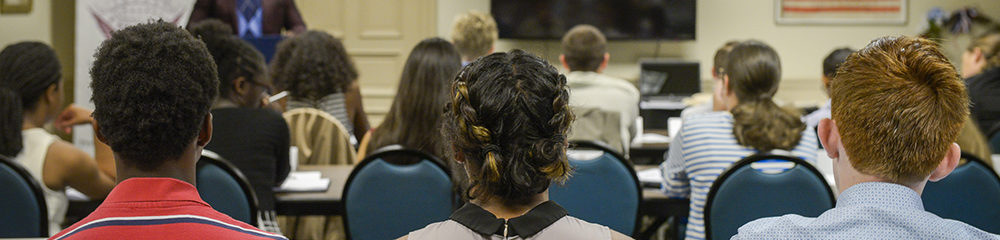 Photograph of students listening to a speaker.