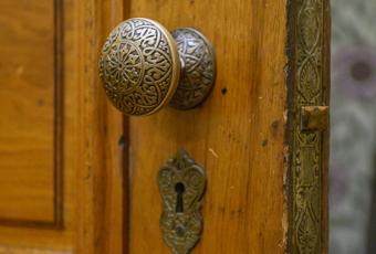 Ornate Victorian door knob at the Benjamin Harrison Presidential Site. The door knob is engraved with an intricate pattern featuring detailed curves and shapes.