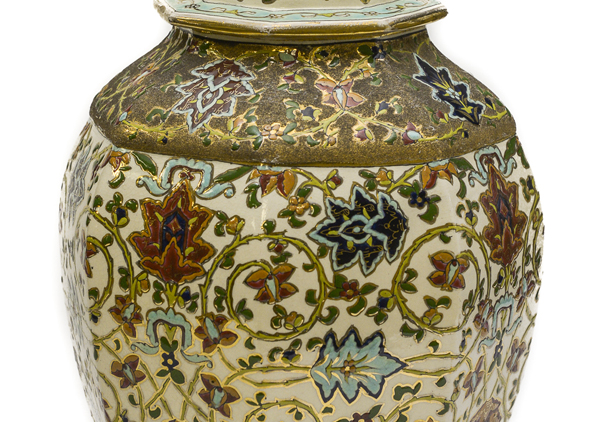 Matched pair of porcelain rose jars (Potpourri jars) with octagon shape, so called as they were filled with dried rose petals. They are Hungarian and have a gold lion on top. The lions are painted with a rough finish gold paint. They have their mouths open and one paw up on a bright and smooth gold ball. Ornately painted with red, blue, and dark yellow flowers with green leaves and vines on white background with gold trim at top.