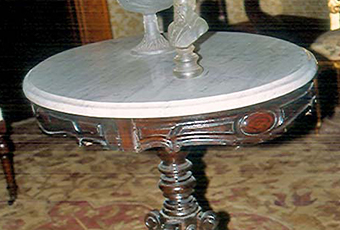 Marble top table, standing on a pedestal with 4 branching 